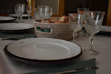 Mesa con cubiertos modernos, copa, cesta con pan 