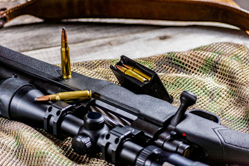 Rifle bolt action sniper weapon gun and ammo isolated on multicam background