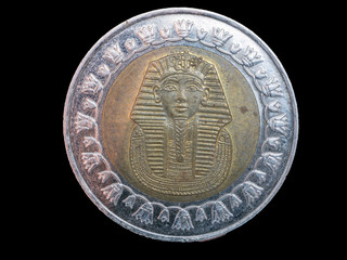 one pound coin on black background