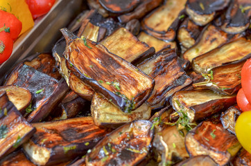 Fresh vegetables grilled on fire outdoors.