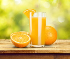 Orange juice and slices of orange on background