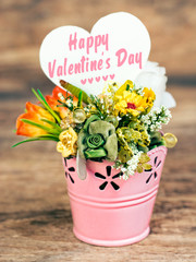 bouquet of flowers in rosy decorative bucket, note and space for text. Happy Valentine's Day card 