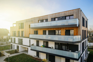 Modern townhouses in a residential area with multiple new apartments buildings surrounded by green...