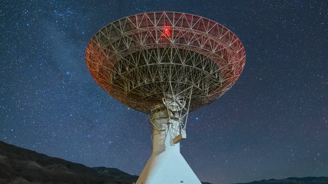 Astro Timelapse Pan Shot of Starry Sky over Large Radio Telescope -Zoom In-