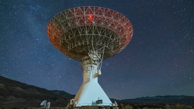 Astro Timelapse Pan Shot of Starry Sky over Large Radio Telescope