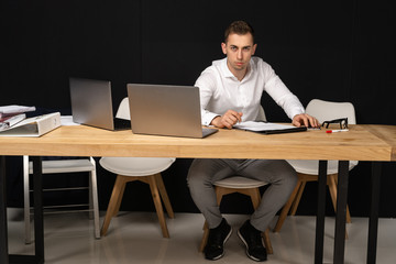 Focused serios businessman thinking of online task