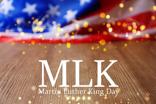 Blurred American flag and garland on wooden table. Space for text