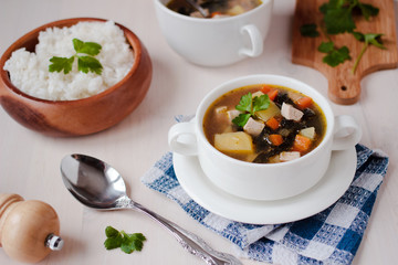 Healthy vegan veggie soup with tofu, potatoes and seaweeds