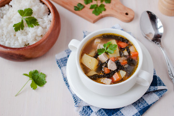 Healthy vegan veggie soup with tofu, potatoes and seaweeds
