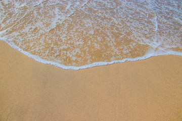 Soft waves on the sandy beach.