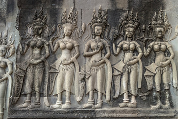 Devatas and Apsaras were revered in ancient Cambodian culture. Khmer people considered them descended from gods and goddesses. One of many bas reliefs in Angkor Wat Temple. Siem Reap, Cambodia.