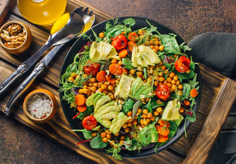 Avocado, roasted tomato, greens and chickpeas salad