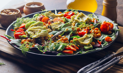 Avocado, roasted tomato, greens and chickpeas salad