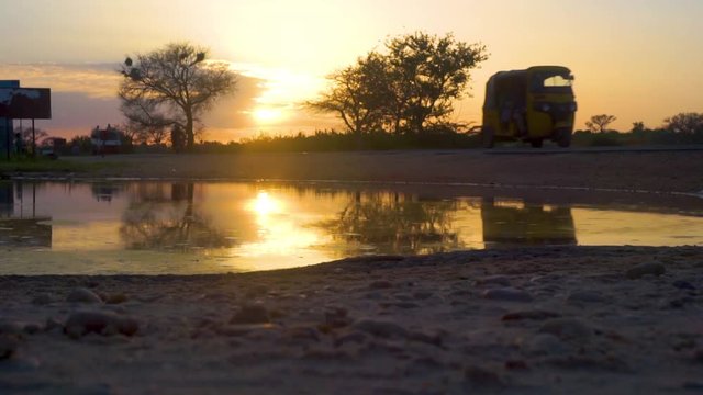 African road reflection at sunset