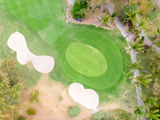 Birds eye view of golf course hole green and sand traps. Drone shot.