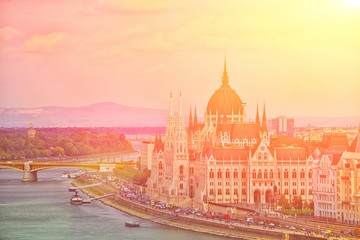 Obraz premium A landscape view of Budapest city at daytime, the Hungarian parliament building and other buildings along Danube river, Hungary. One of the most beautiful building in the Hungarian capital.