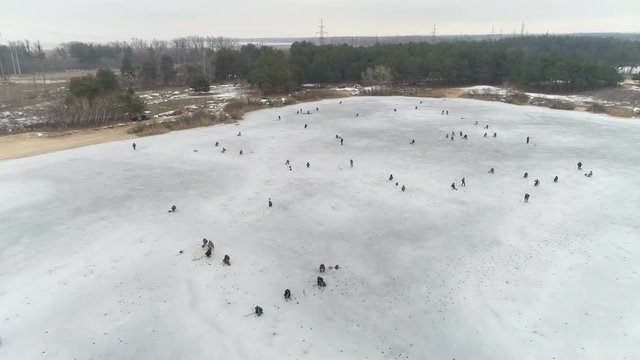 Aerial View Of River, Fishermen on Ice. Cloudy Winter Day. Energodar, Ukraine. 4K video