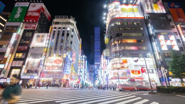 Timelapse of Busy Downtown Crosswalk at Night in Shinjuku, Front View -Zoom In-