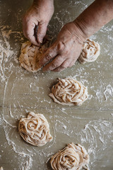 Chef preparing raw tagliatelle nests