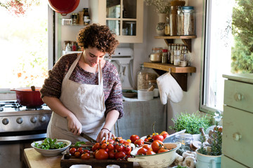 Woman slicing tomatoes for pasta sauce