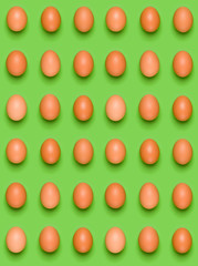 Eggs pattern on green background. Easter concept. Flat lay, top view. Food background.