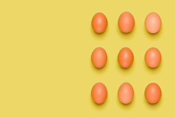 Eggs pattern on yellow background. Easter concept. Flat lay, top view. Food background. Copy space.