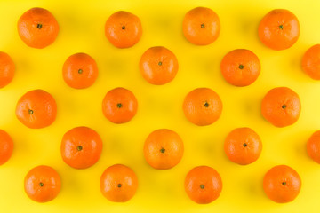 Fruit pattern of mandarin isolated on yellow background. Tangerine. Flat lay, top view.