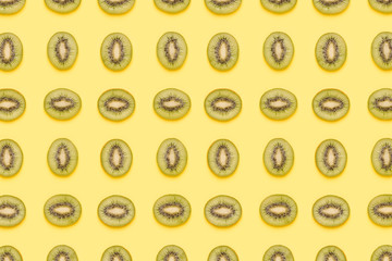 Kiwi slices pattern on green background. Food background. Fruit pattern.  Pop art design, creative summer concept.