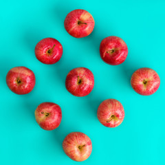 Fruit pattern of red apple on blue background. Flat lay, top view. Pop art design, creative summer concept. Food background.