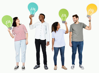 Naklejka premium People carrying light bulb icons
