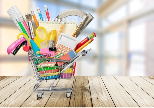 Stationery Objects In Mini Supermarket Cart On  Background