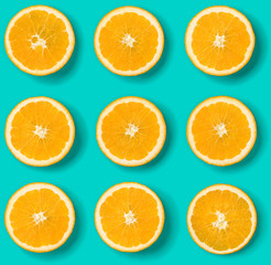 Fruit pattern of orange slices on blue background. Flat lay, top view. Food background.