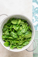 Fresh green spinach in a colander