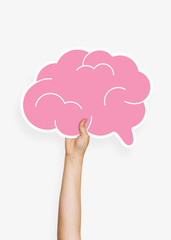 Hand holding a brain cardboard prop
