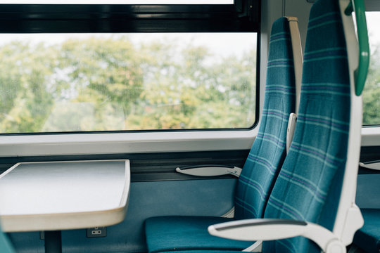 Fototapeta Empty seats with a tray on a train