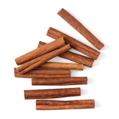 Cinnamon sticks isolated on white background closeup. Canella spice. Aromatic condiment background. Flat lay, top view.