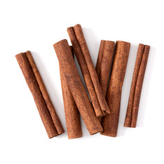 Cinnamon sticks isolated on white background closeup. Canella spice. Aromatic condiment background. Flat lay, top view.
