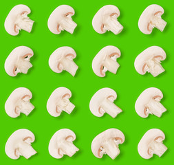 Seamless pattern of champignon slices on green background. Flat lay, top view. Food background. .  Pop art design, creative concept.