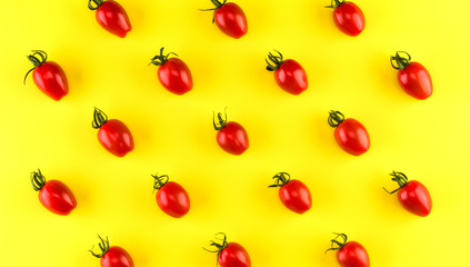 Food pattern of cherry tomato  isolated on yellow background. Flat lay, top view.