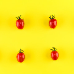Food pattern of cherry tomato  isolated on yellow background. Flat lay, top view.