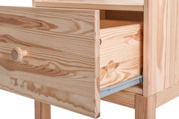 Wooden small cabinet with open drawer on white background, closeup. Furniture for wardrobe room