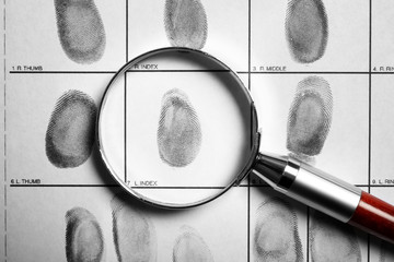 Criminal fingerprint card and magnifier, top view