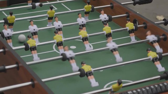 Table football in the entertainment center. Close-up image of plastic players in a football game.