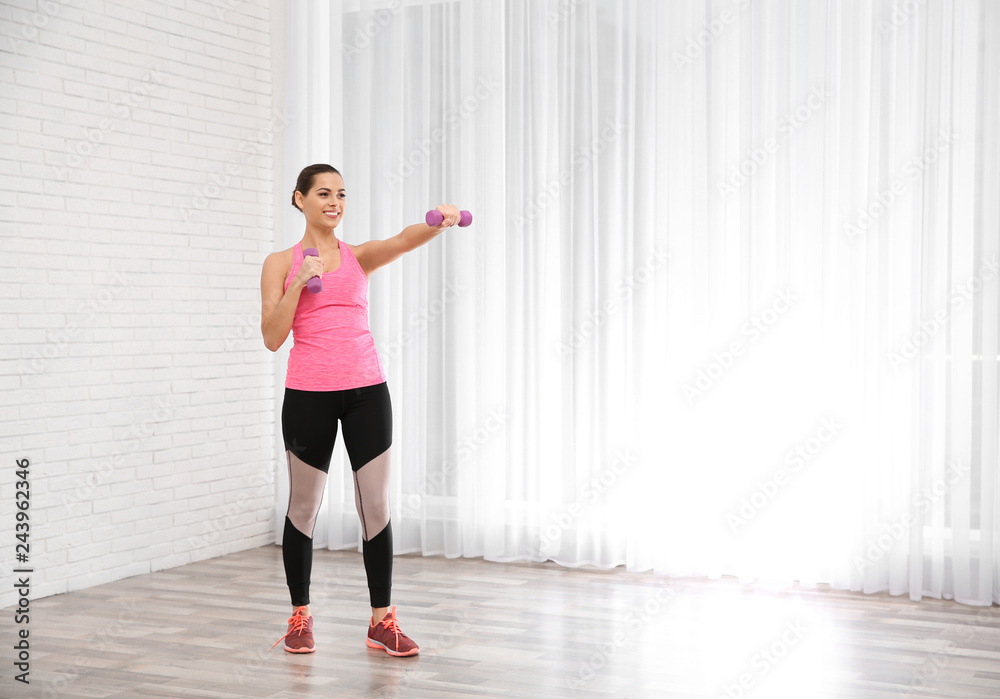 Poster Young beautiful woman with dumbbells doing exercise at home, space for text. Workout and fitness