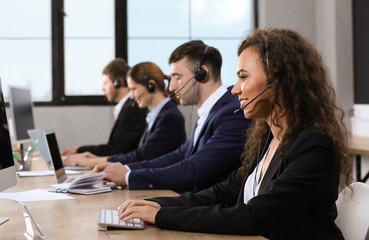 Team of technical support with headsets at workplace