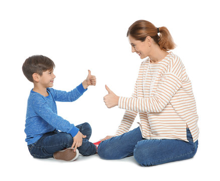 Hearing impaired mother and her child talking with help of sign language on white background