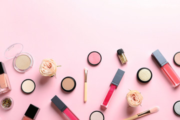 Beautiful composition with lipsticks and flowers on color background, flat lay