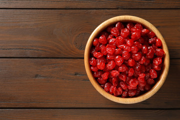 Bowl of sweet cherries on table, top view with space for text. Dried fruit as healthy snack