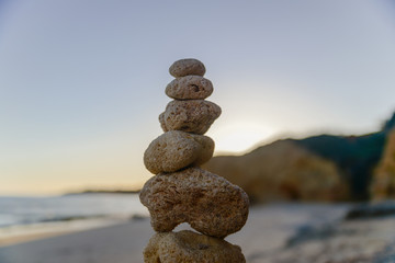 Fototapeta na wymiar Stones balance on beach, sunset shot