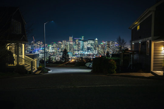 Seattle Neighborhood Residential Street View of Bright City Skyline at Night